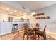 Bright dining area with glass table, seating for four, and open view to the kitchen at 5300 S Atlantic Ave # 1-603, New Smyrna Beach, FL 32169