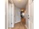 Long hallway with wood floors and white doors leading to other rooms in the home at 5300 S Atlantic Ave # 1-603, New Smyrna Beach, FL 32169