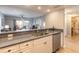 Open concept kitchen with a breakfast bar overlooking the living room and featuring white cabinets and stainless appliances at 5300 S Atlantic Ave # 1-603, New Smyrna Beach, FL 32169