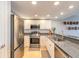 Modern kitchen featuring stainless steel appliances, granite countertops, and white cabinets at 5300 S Atlantic Ave # 1-603, New Smyrna Beach, FL 32169