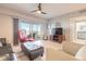 Cozy living room with neutral paint, hardwood floors, ceiling fan, balcony access and a view to the bathroom at 5300 S Atlantic Ave # 1-603, New Smyrna Beach, FL 32169