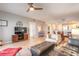 Open concept living room features a leather sofa, wood floors, and views into the kitchen at 5300 S Atlantic Ave # 1-603, New Smyrna Beach, FL 32169