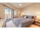 This main bedroom features a ceiling fan, private balcony, and lots of natural light at 5300 S Atlantic Ave # 1-603, New Smyrna Beach, FL 32169