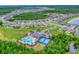Gorgeous aerial view of the community pool, tennis courts, and surrounding homes at 534 Stowers Dr, New Smyrna Beach, FL 32168