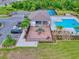 Overhead view featuring community pool, playground, parking, and lush landscaping in a desirable location at 534 Stowers Dr, New Smyrna Beach, FL 32168