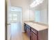 Bathroom with single sink vanity, and a doorway to the bedroom at 534 Stowers Dr, New Smyrna Beach, FL 32168