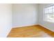 Cozy bedroom with wood-look flooring and a large window, offering a comfortable space at 534 Stowers Dr, New Smyrna Beach, FL 32168