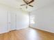 This bedroom features a ceiling fan, a window, and wood plank flooring at 534 Stowers Dr, New Smyrna Beach, FL 32168