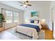 Bright bedroom showcases a comfortable bed, stylish lamps, and large windows, creating tranquil atmosphere at 534 Stowers Dr, New Smyrna Beach, FL 32168