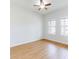 Bright bedroom with a ceiling fan and natural light, showcasing the wood-look flooring at 534 Stowers Dr, New Smyrna Beach, FL 32168