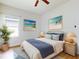Inviting bedroom with a ceiling fan, beach-themed decor, and warm lighting to create a relaxing atmosphere at 534 Stowers Dr, New Smyrna Beach, FL 32168