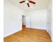 This bedroom features wood plank flooring, a ceiling fan, and white walls at 534 Stowers Dr, New Smyrna Beach, FL 32168