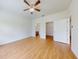 This main bedroom features natural light, wood-look floors, and entry to the ensuite bath and walk-in closet at 534 Stowers Dr, New Smyrna Beach, FL 32168