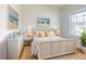 Bright bedroom showcasing a stylish bed frame, cheerful yellow accents, and a large window for plenty of light at 534 Stowers Dr, New Smyrna Beach, FL 32168