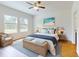 Serene bedroom features a cozy bed, stylish lamps, and a wicker chair, offering a relaxing retreat at 534 Stowers Dr, New Smyrna Beach, FL 32168