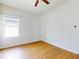 This bedroom features a ceiling fan, a window, and wood plank flooring at 534 Stowers Dr, New Smyrna Beach, FL 32168