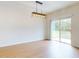 Well-lit dining area featuring sliding glass doors and hardwood floors at 534 Stowers Dr, New Smyrna Beach, FL 32168