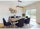 Bright dining room features modern lighting, stylish decor, and a sliding glass door that allows natural light at 534 Stowers Dr, New Smyrna Beach, FL 32168