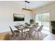Bright dining room featuring a modern chandelier, modern dining set, and sliding glass doors at 534 Stowers Dr, New Smyrna Beach, FL 32168