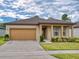 Charming single-story home with a well-manicured lawn, a two-car garage, and a covered front porch at 534 Stowers Dr, New Smyrna Beach, FL 32168