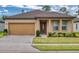 Inviting single-story home with a two-car garage, manicured lawn, and a charming entryway at 534 Stowers Dr, New Smyrna Beach, FL 32168