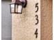Close-up of the house number '534' beside a textured wall and outdoor light at 534 Stowers Dr, New Smyrna Beach, FL 32168