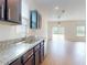 This kitchen features stainless steel appliances, granite countertops, and dark wood cabinets at 534 Stowers Dr, New Smyrna Beach, FL 32168
