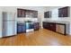 This kitchen features stainless steel appliances, granite countertops, and dark wood cabinets at 534 Stowers Dr, New Smyrna Beach, FL 32168