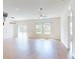 Spacious living room with natural light, ceiling fan, and sliding glass door at 534 Stowers Dr, New Smyrna Beach, FL 32168