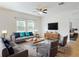 Bright living room showcasing stylish gray sofas and chairs, modern furnishings, and a ceiling fan at 534 Stowers Dr, New Smyrna Beach, FL 32168