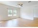 Well-lit living area showcasing hardwood floors, ceiling fan, and ample windows at 534 Stowers Dr, New Smyrna Beach, FL 32168