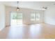 Spacious living area with ceiling fan, sliding glass door, and ample natural light at 534 Stowers Dr, New Smyrna Beach, FL 32168