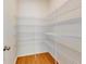 This pantry features adjustable metal shelving and wood-look floors at 534 Stowers Dr, New Smyrna Beach, FL 32168