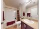 Well-lit bathroom with a bath, toilet, sink, and dark wood vanity at 535 Coral Trace Blvd, Edgewater, FL 32132