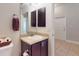 Small bathroom with a dark wood vanity, sink, towel rack, toilet, and decorative basket at 535 Coral Trace Blvd, Edgewater, FL 32132