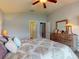 Comfortable bedroom featuring a dresser, and natural light from the windows and entry to bathroom at 535 Coral Trace Blvd, Edgewater, FL 32132