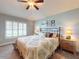 Comfortable bedroom featuring a bed, bedside tables, and natural light from the windows at 535 Coral Trace Blvd, Edgewater, FL 32132