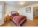 Cozy bedroom featuring a decorative iron bed, carpet, and bedside table with lamps at 535 Coral Trace Blvd, Edgewater, FL 32132