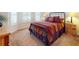 Comfortable bedroom featuring a metal bed frame, plush carpet, and ample natural light at 535 Coral Trace Blvd, Edgewater, FL 32132