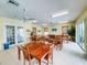 Sunlit community room showcasing wood tables, ceiling fans, and comfortable seating areas at 535 Coral Trace Blvd, Edgewater, FL 32132