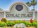 Attractive Coral Trace community sign with lush landscaping in a well maintained development at 535 Coral Trace Blvd, Edgewater, FL 32132