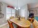 Comfortable dining area featuring a wooden table and chairs, adjacent to natural light and decor at 535 Coral Trace Blvd, Edgewater, FL 32132
