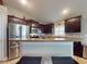Stylish kitchen featuring stainless steel appliances and plenty of storage space and breakfast bar at 535 Coral Trace Blvd, Edgewater, FL 32132