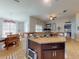 Bright and airy kitchen with countertop dining area, dining room and living room in view at 535 Coral Trace Blvd, Edgewater, FL 32132