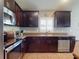 Well-equipped kitchen with stainless steel appliances, ample counter space, and sleek dark cabinetry at 535 Coral Trace Blvd, Edgewater, FL 32132