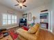 Inviting living room with a comfortable sofa, large windows, and decorative accents at 535 Coral Trace Blvd, Edgewater, FL 32132