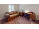 Office with a cozy sofa and wooden desk, creating a functional yet inviting workspace in the home at 535 Coral Trace Blvd, Edgewater, FL 32132