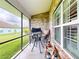 Screened patio with outdoor seating area, creating an ideal space for relaxation and entertaining at 535 Coral Trace Blvd, Edgewater, FL 32132