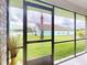 Screened-in patio area, offering views of the lush backyard and serene lakeside setting at 535 Coral Trace Blvd, Edgewater, FL 32132