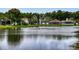 Scenic view of pond with fountain, surrounded by lush greenery and neighborhood homes at 535 Coral Trace Blvd, Edgewater, FL 32132